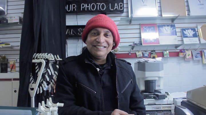 Photo of Gazi Alam smiling at Quik-Pix Photo Lab.
