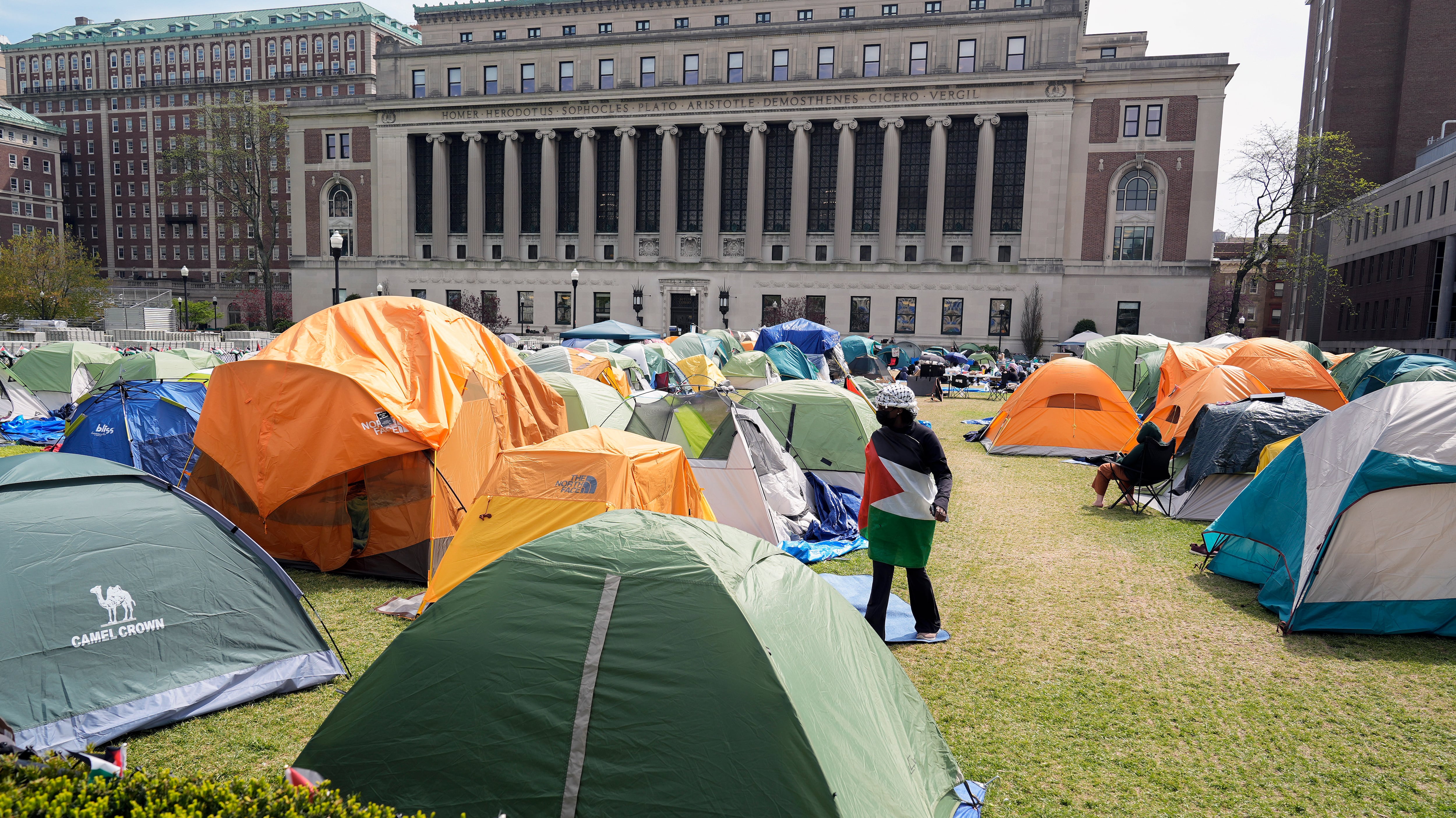 Photo of tents on a lawn in front of Columbia University.