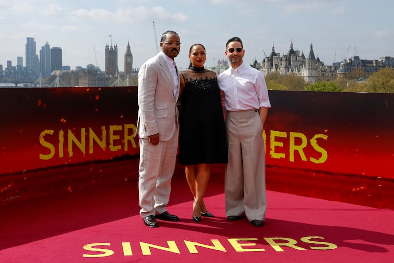 Coogler is wearing a tan suit and his wife is wearing a black dress. Sev is wearing tan pants and white shirt