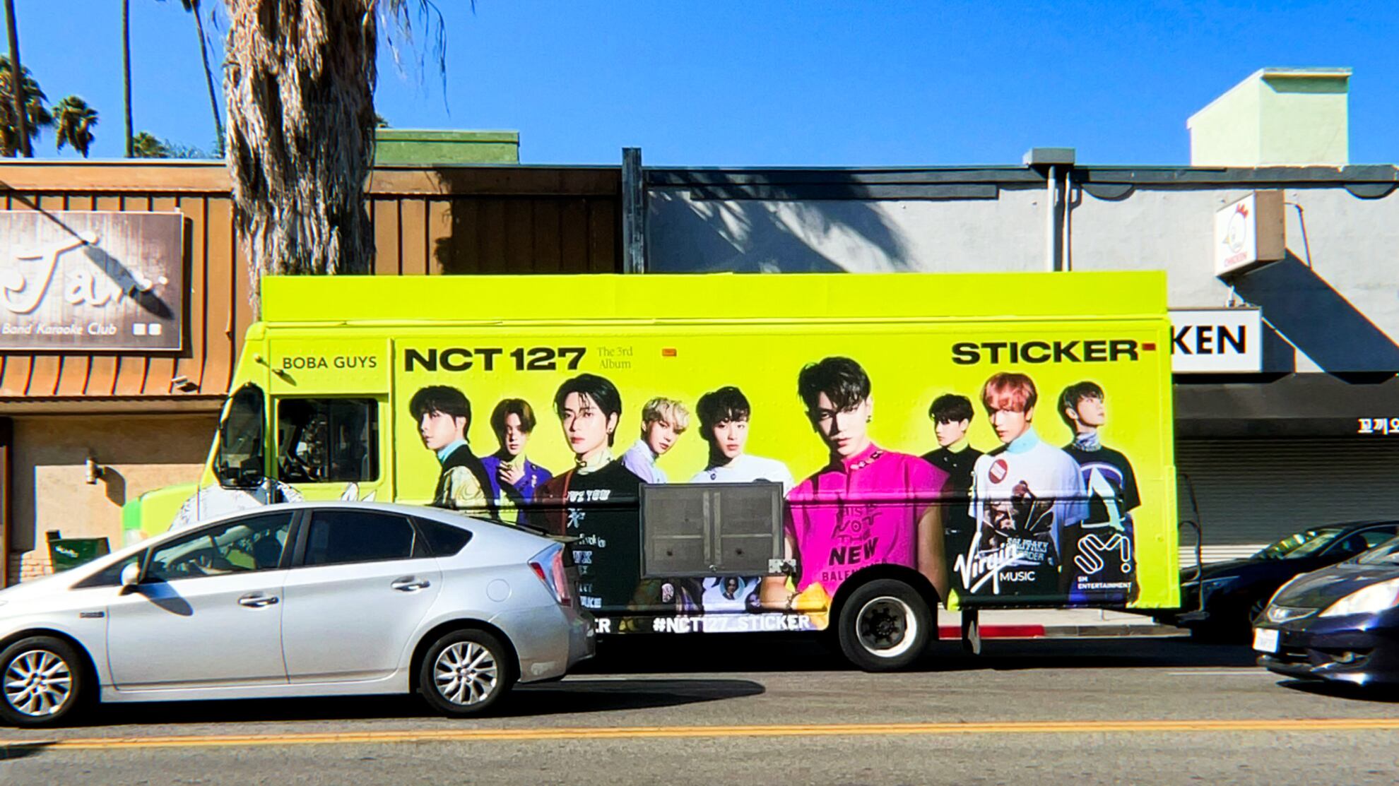 A photo of the NCT 127 sticker bus from their pop-up with Boba Guys.