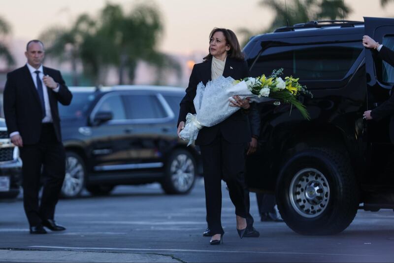 Kamala Harris brings flowers to the Monterey Park vigil after a mass shooting at a local dance studio.