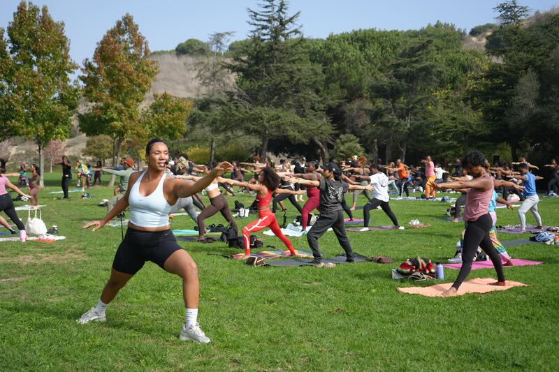 Marley Rae Ralph (aka Namaste Marley Rae) leading participants in yoga.