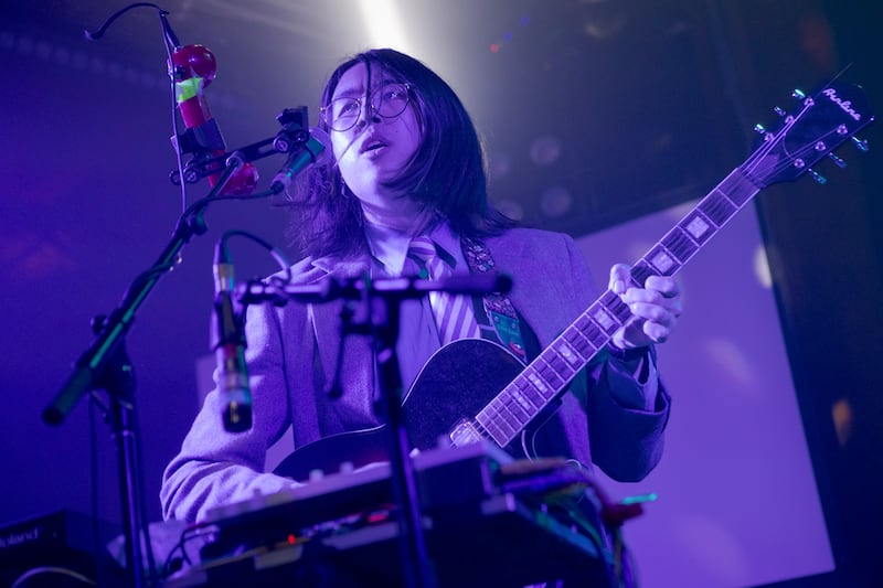 Guitarist playing with blue lights