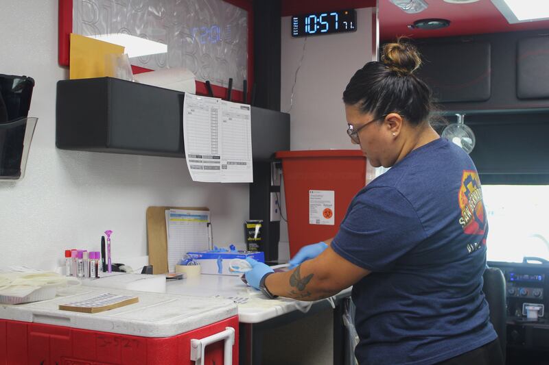 LifeStream phlebotomist Tiffany Guajardo prepares materials for a blood draw. (Photo by Nora Rakoci)