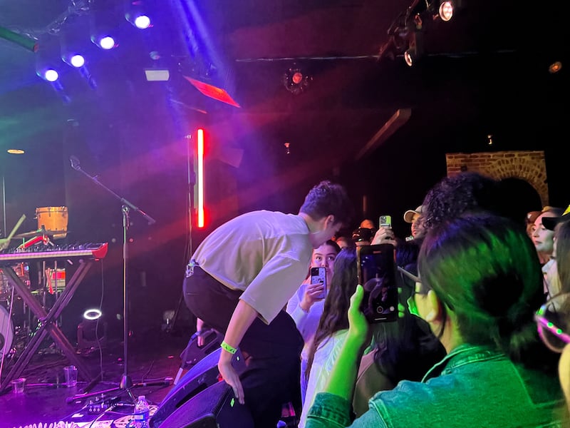 Photo of a man getting off a stage