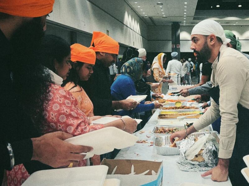 DESCRIBE THE IMAGE FOR ACCESSIBILITY, EXAMPLE: Photo of a chef putting red sauce onto an omelette.