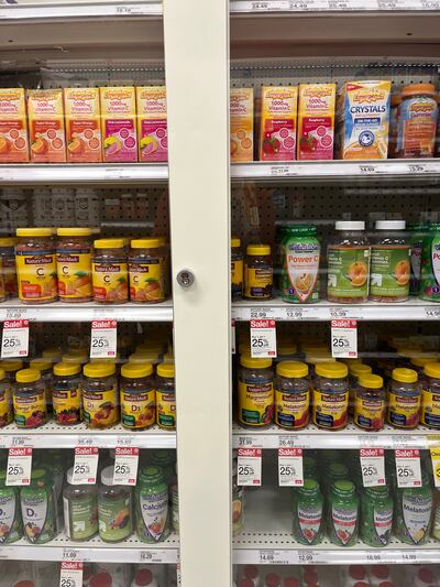 A photo of vitamins behind a locked shelf.