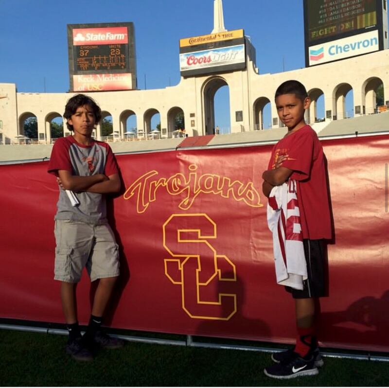 Photo of two boys standing in front of the Los Angeles Coliseum.