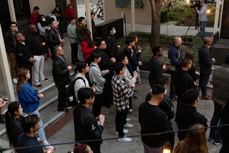 Photo of a crowd of people holding candles