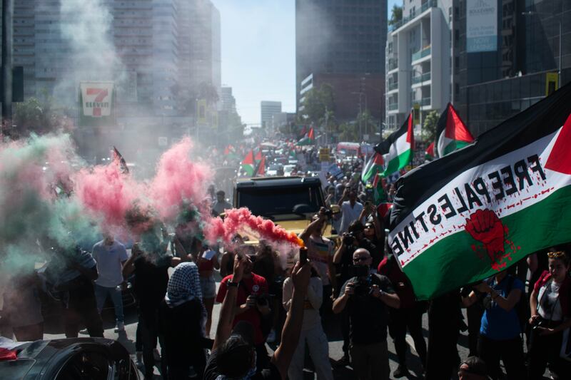 Red and green smoke was released in front of the marching crowd at the “All Out For Gaza” Rally.