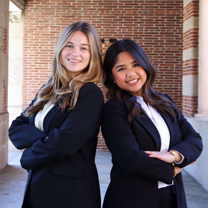Photo of two people posing and smiling.