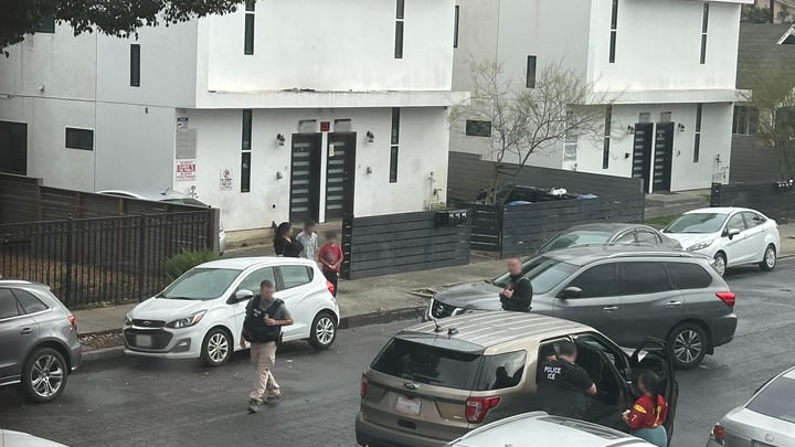 Photo of ICE officers detaining the Columbian man.