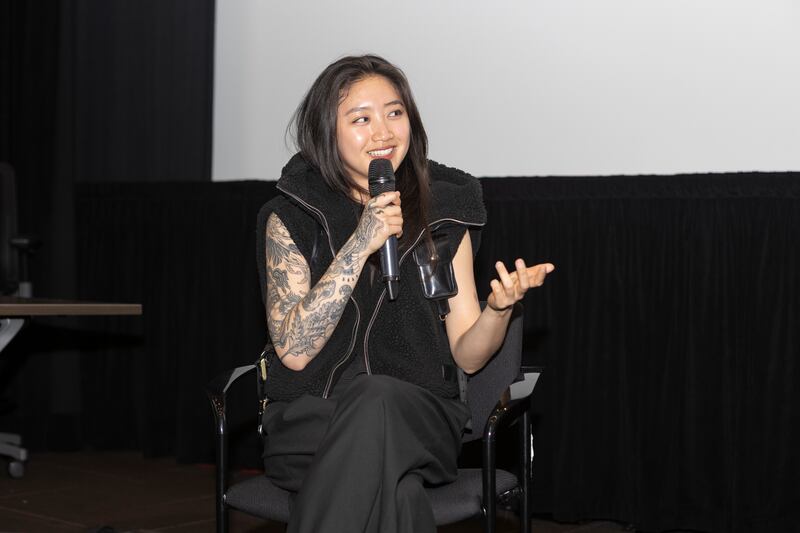 A woman talking into a microphone.