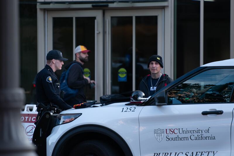 A photo of the suspected shoplifter next to Wallis Annenberg Hall and a DPS vehicle.