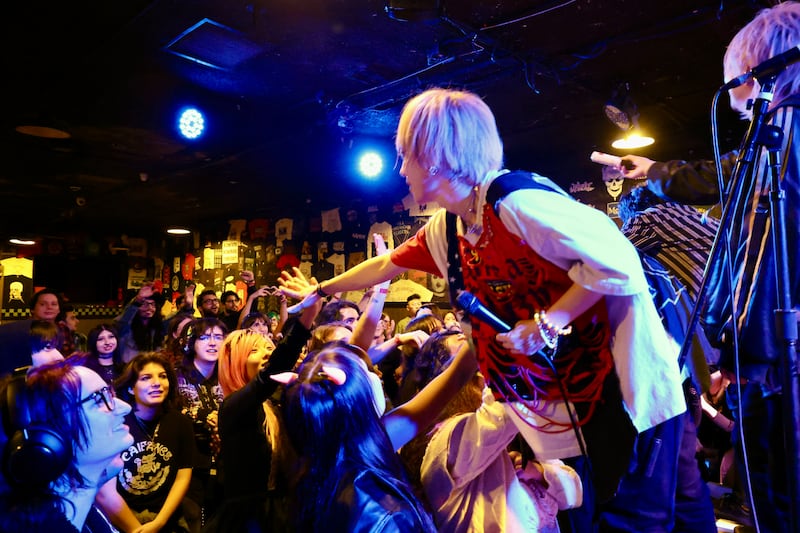 Artist reaching out toward the audience