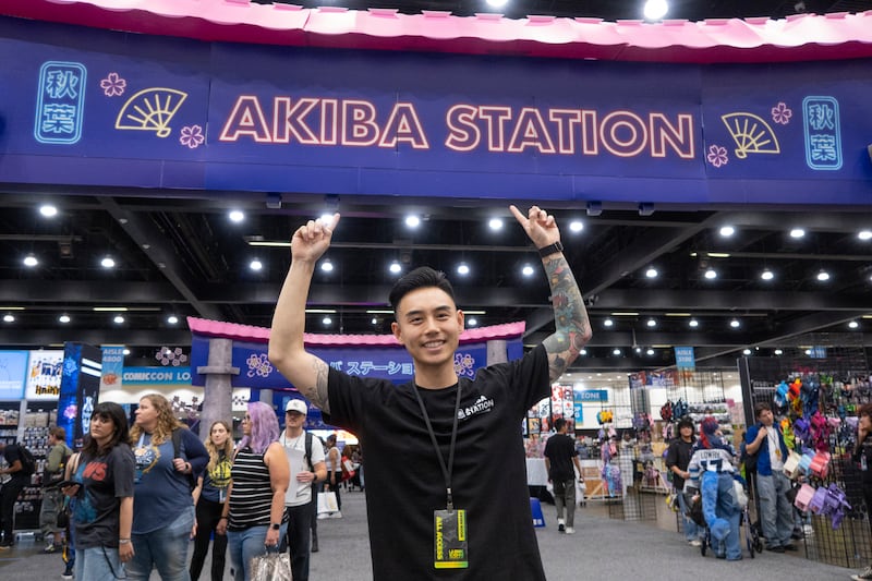 Man poses in front of arches