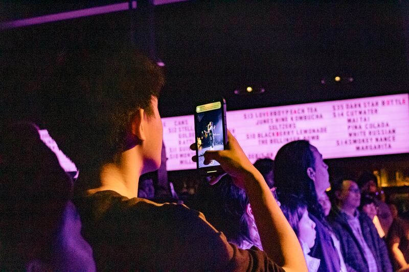 A member of the crowd films a video of 9m88’s performance. (Photo by Marissa Ding)