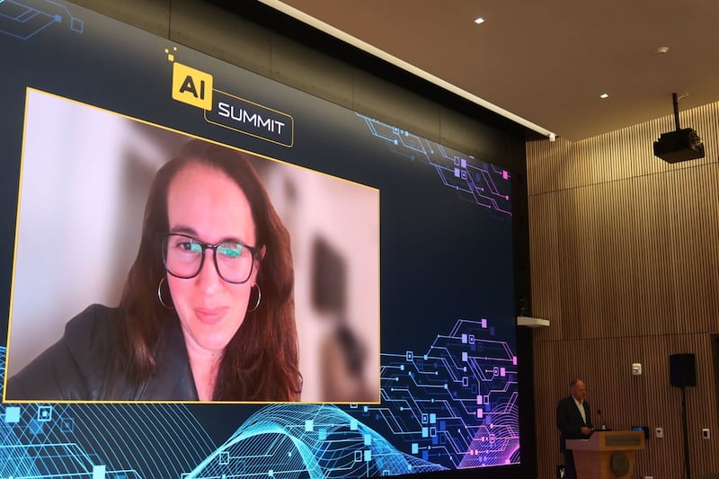 Leah Belsky on the screen and Marshall Dean Geoffrey Garett at the USC AI summit. (photo by Melie Hailemeskel)