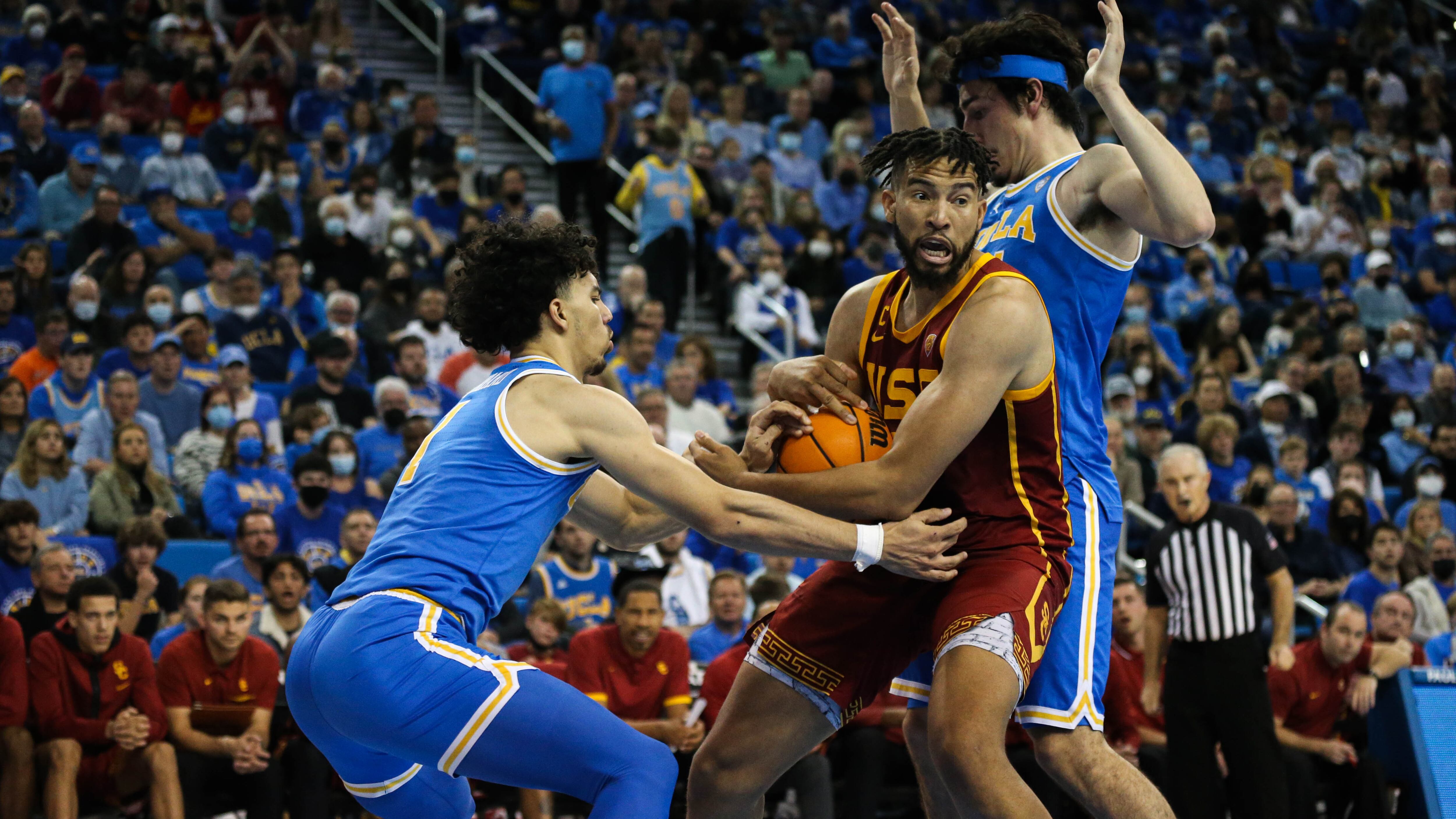 A photo of Isaiah Mobley protecting the ball against UCLA defenders