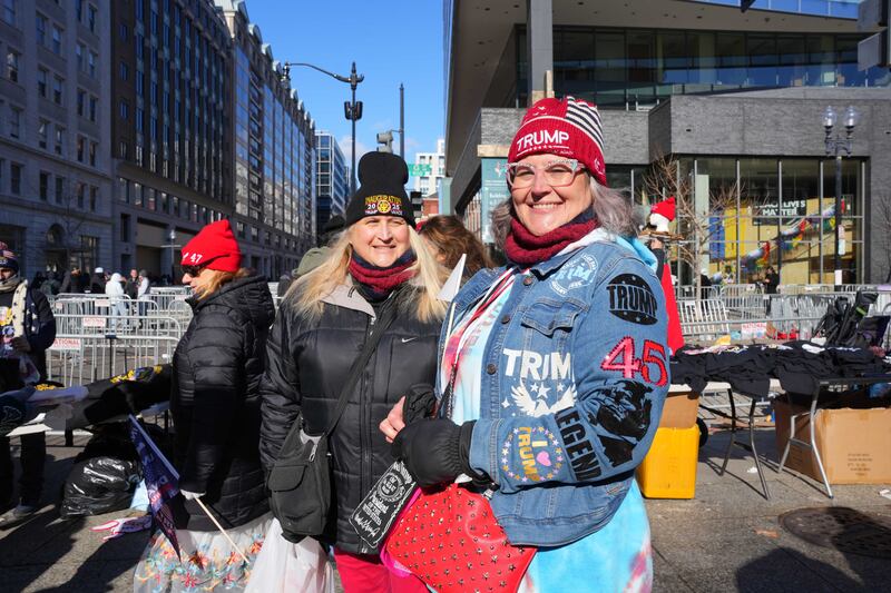Two women wearing Trump merchandise.