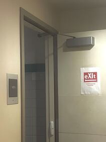 A poster on a door saying "eXIt"
