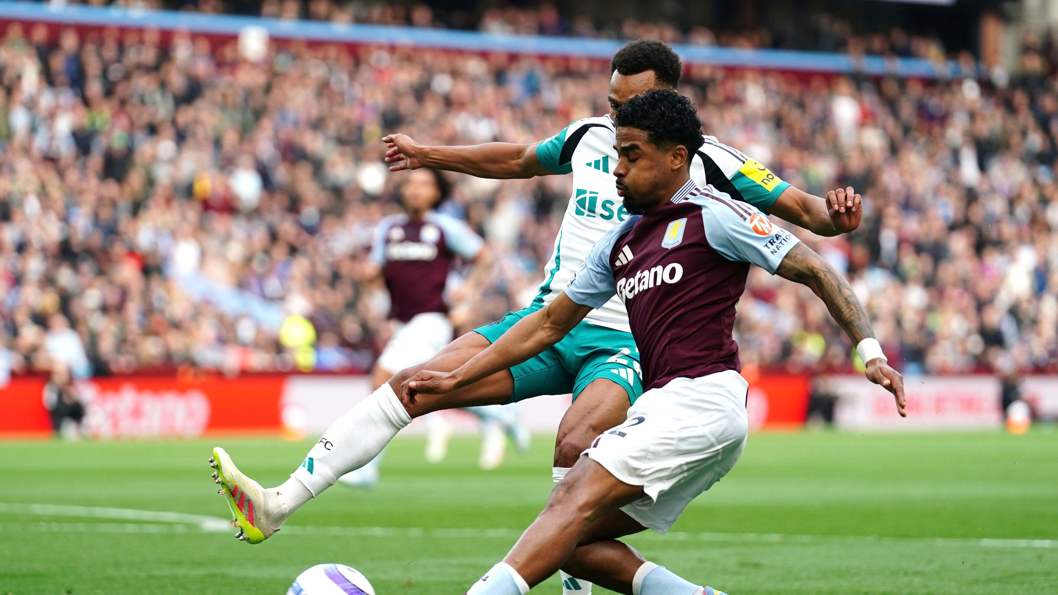 Aston Villa's Ian Maatsen, front, and Newcastle United's Jacob Murphy battle for the ball battle for the ball during the English Premier League soccer match between Aston Villa and Newcastle United at Villa Park, Birmingham, England, Saturday April 19, 2025.
