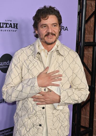 A photo of Pedro Pascal smiling at the camera.