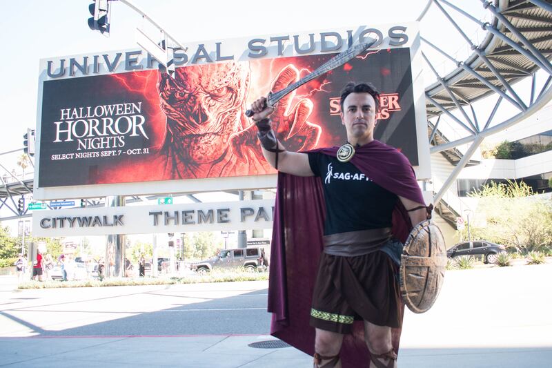 The Mayor of Burbank dressed as a roman gladiator in front of one of the Universal Studios' entrances.