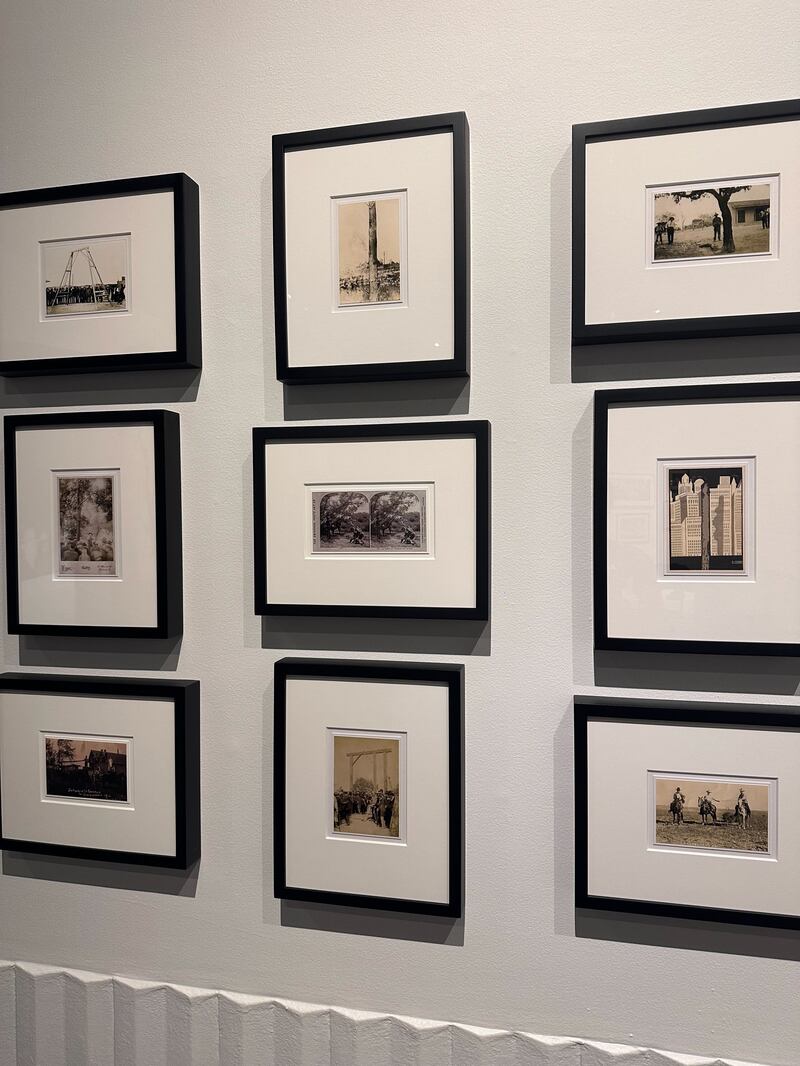 Photo of several photographs of lynching sites, with no body visible. The tree or setup is the only thing present in the photograph.