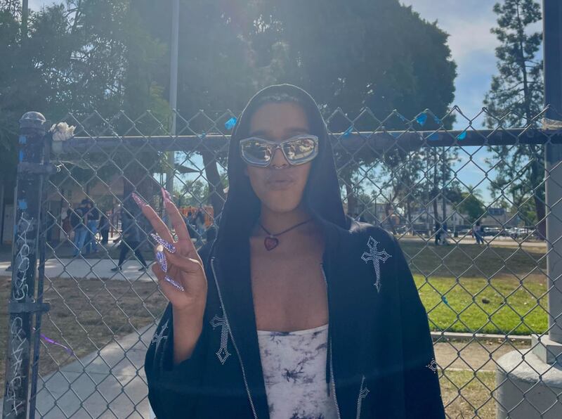 A person in a black hoodie and reflective sunglasses.
