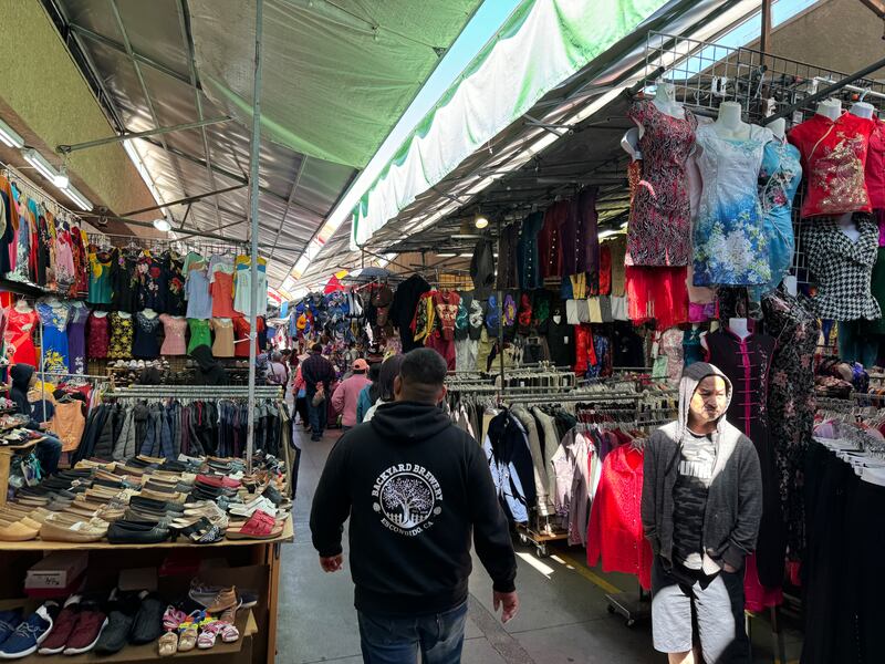 Photo of a swap meet with a tarp covering the overhead