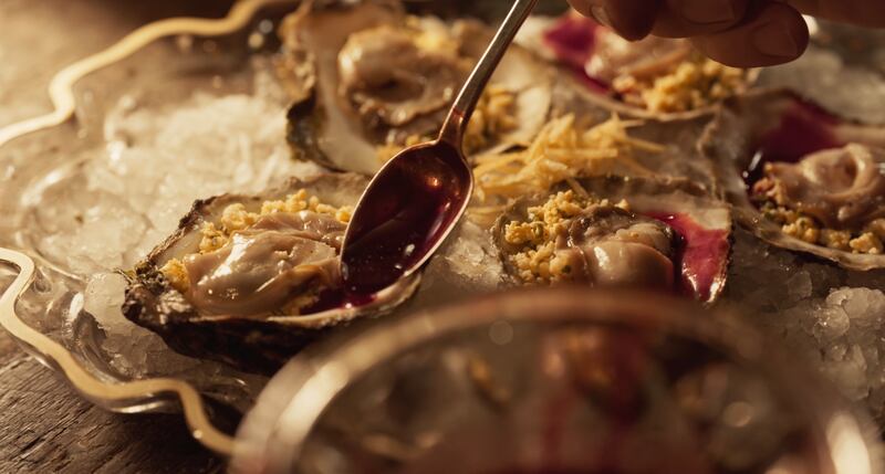Close up shot of oyster with spoon.