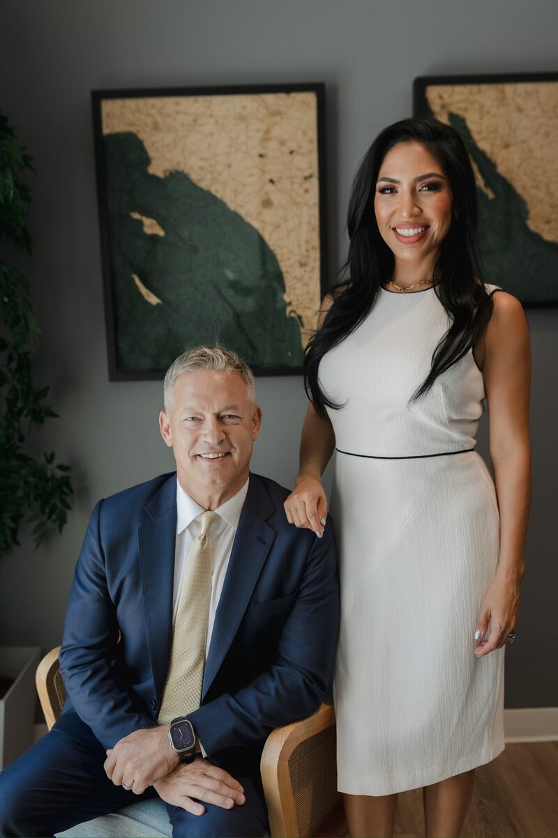 Photo of a man and a woman posing for a camera.