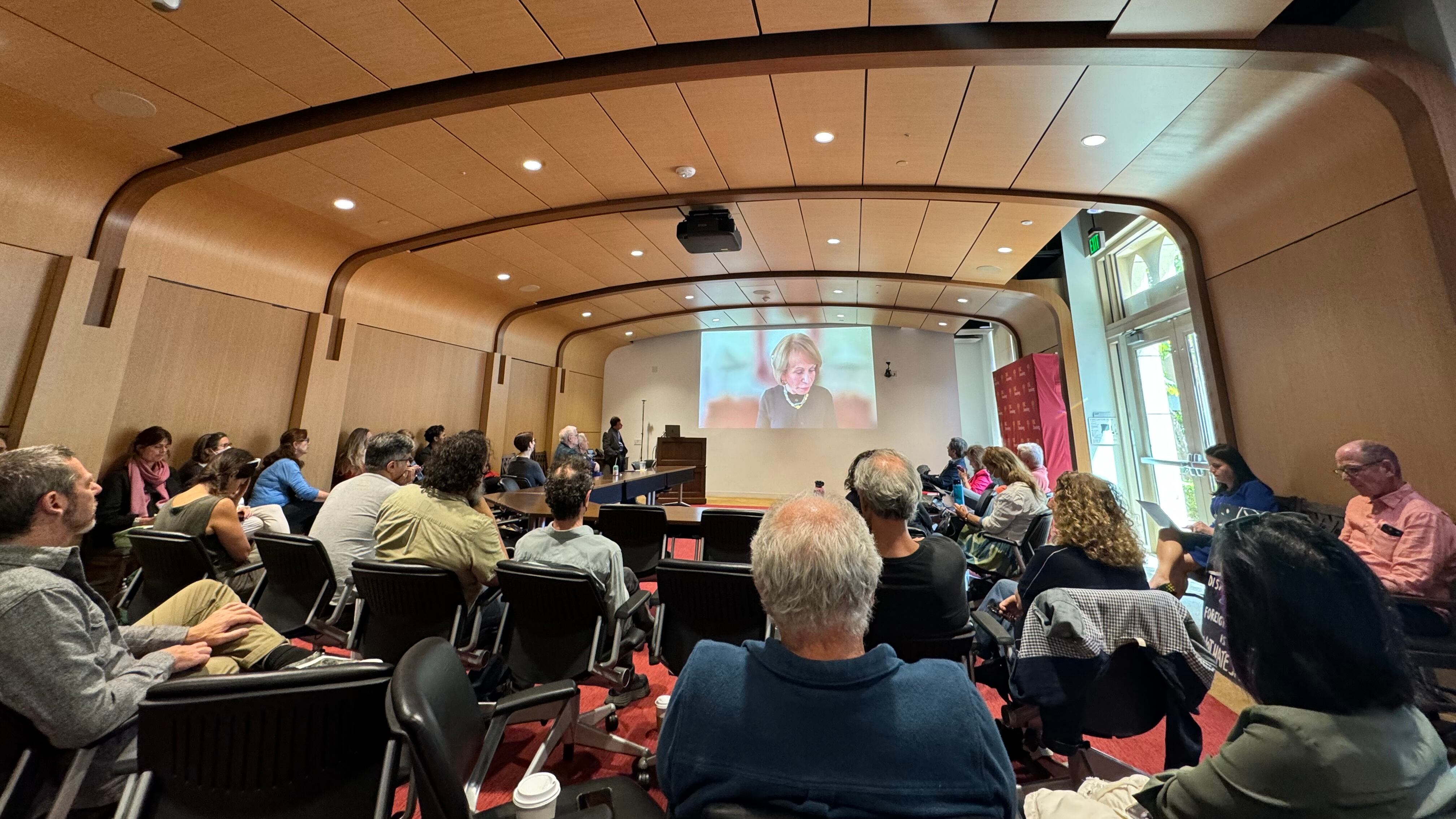faculty joining in a room watching a screen