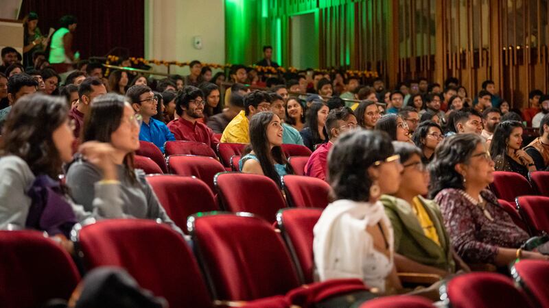 Audience members smile at the event put up by the Association of Indian Students.