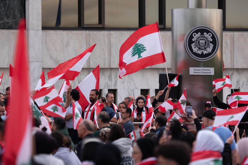 Photo of hundreds of people waving Lebanese flags at a rally to protest recent Israeli airstrikes against Hezbollah, at the Henry Ford Centennial Library in Dearborn, Michigan on Wednesday, Sept. 25, 2024.