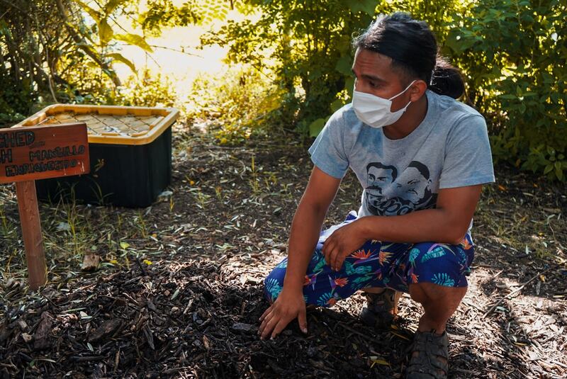 Jonathan Galindez sitting in the soil.