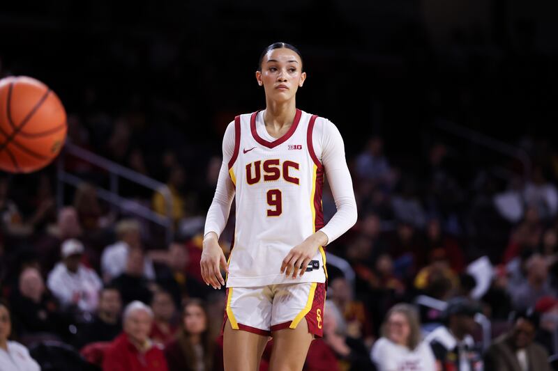 Jazzy Davidson (9) on court at Galen Center wearing a white basketball uniform with cardinal and gold accents.