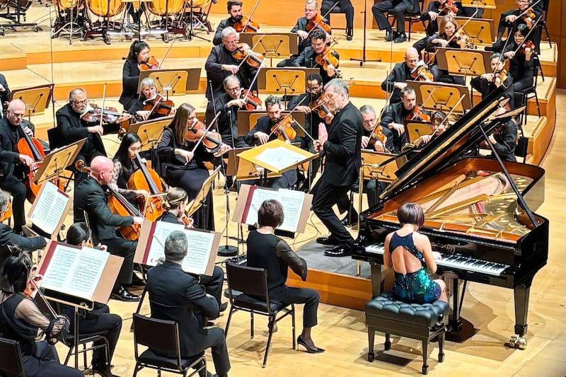 a pianist and a conductor performing on stage