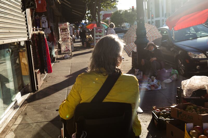 Leung-Astwood looks at a street vendor’s wares in Chinatown.