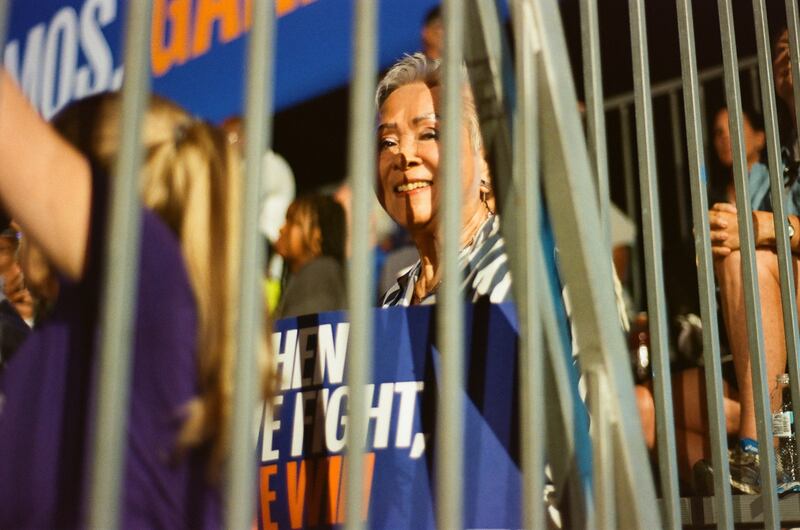 A voter holding a “When we fight, we win” sign at a Harris campaign rally in Las Vegas at World Market Center on Sept. 29, 2024.