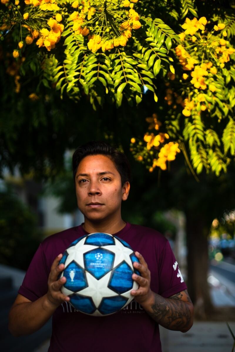 A photo of Gael Ortiz holding a soccer ball near his home in Long Beach, Calif.