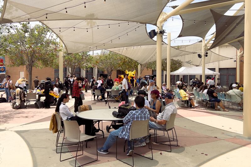 Attendees socialize in several seating areas.