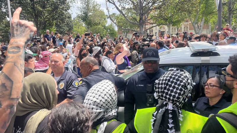 Officers standing in a crowd.