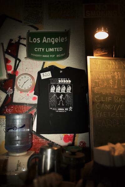 A photo of a t-shirt available for sale hanging on the wall.