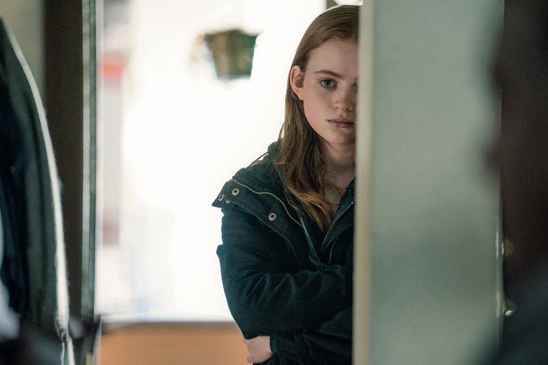 Film shot of a girl standing behind a pillar