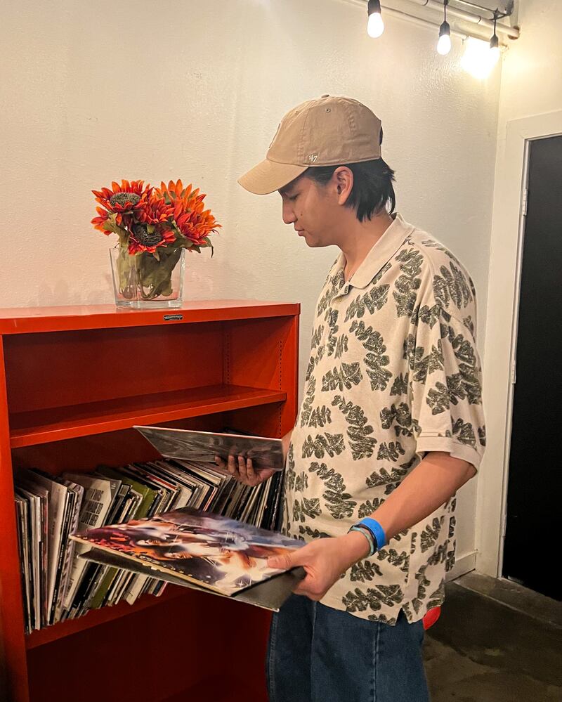 Photo of a man looking through albums