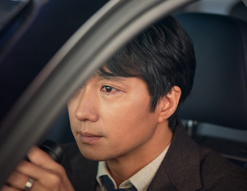 Film shot of a man sitting in a car