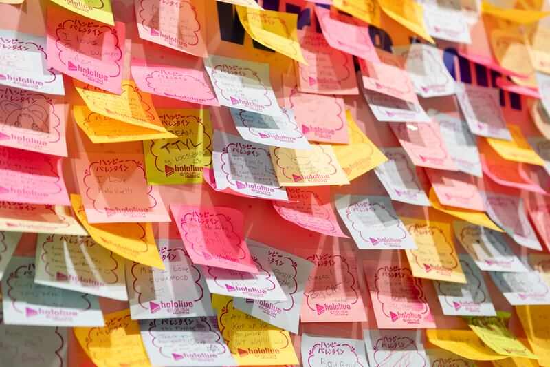 Photo of a wall of sticky notes with writing on them