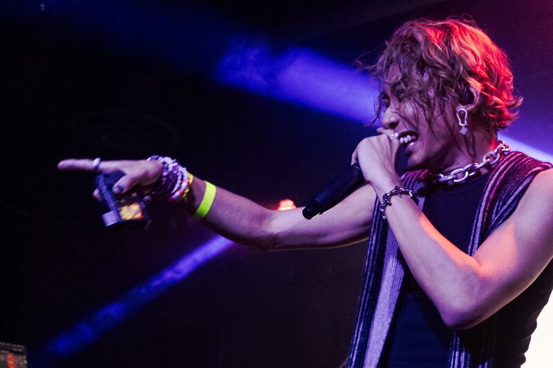 Photo of a man with a microphone pointing